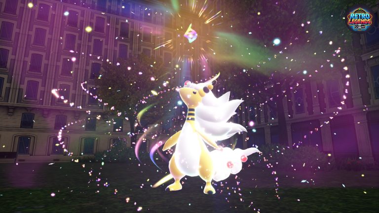 Kampfszene aus Pokémon Legenden Z-A: Ein Ampharos durchläuft eine Mega-Entwicklung mitten in Lumiose City. Umgeben von funkelnden Lichtern und Partikeln entfaltet sich die ikonische Animation, die Mega-Energie im Spiel sichtbar macht. Der Screenshot zeigt die Verbindung zwischen Nostalgie und moderner Präsentation.