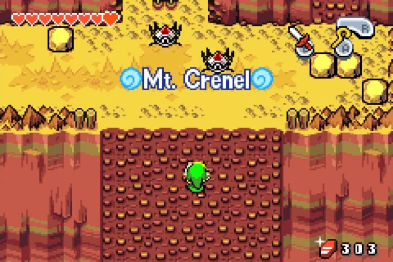 Link klettert eine rotbraune Felswand hoch, gelbe Bergterrasse mit Feinden oben; Einblendung „Mt. Crenel“ und HUD mit Rubinen sichtbar.