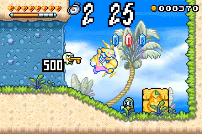 Strandszene mit blauem Himmel; Wario prallt in gelber Aura gegen einen Gegner, oben großer Countdown und Punktzahl, rechts Sammel‑Juwelen über einer Palme.